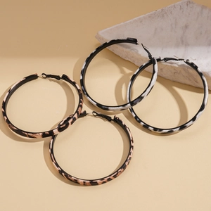 Pair of retro leopard and zebra print hoop earrings with a chic geometric metal design