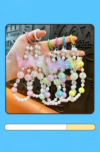 Detailed view of colorful luminous butterfly beaded charms for phone bags and keys.