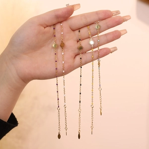 Close-up of gold stainless steel sun bracelets with colorful beads on a model hand