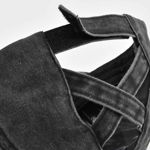 Detail of ponytail baseball cap featuring elastic criss-cross straps and velcro closure