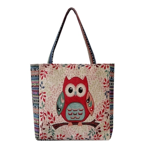Ethnic style woven canvas tote bag featuring a red owl jacquard pattern with striped handles