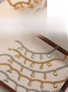 Detail of gold and silver ocean themed charms like starfish and seahorses on metal chains