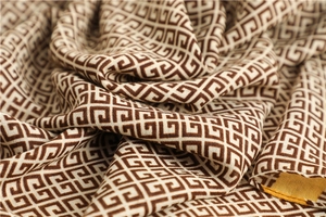 Macro view of brown and beige geometric pattern cotton linen scarf fabric