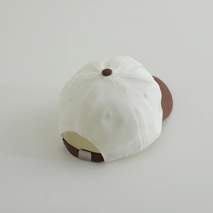 White and brown two-tone kids baseball cap with metal buckle adjustment from back view