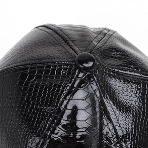 Detail of black faux crocodile texture on the six-panel crown of a hip-hop snapback hat