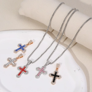 Titanium steel cross necklaces set with colorful zircon stones on ceramic tray