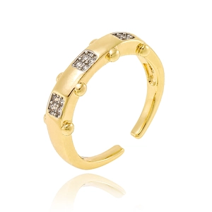 Detailed view of gold open ring with square-set micro-pave zircons and metallic accents