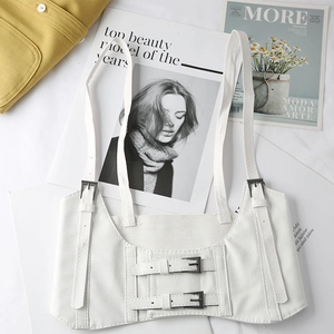 Flat lay of white leather punk style corset vest with adjustable double-buckle straps