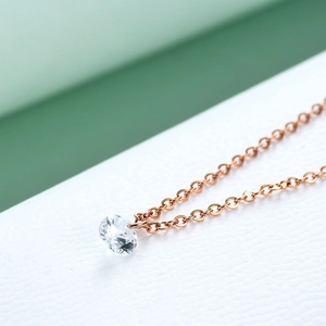 Minimalist 6mm round crystal necklace with a rose gold chain on a clean backdrop