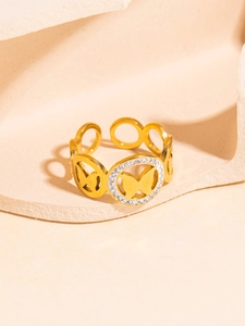 Detail of adjustable gold butterfly ring with sparkling zircon pavé in a circular frame