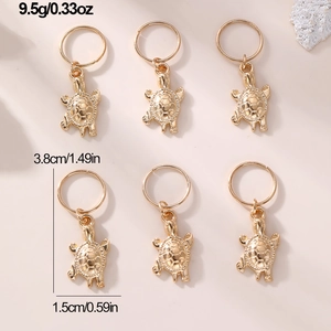 Detail showing 6 gold sea turtle braid charms with size and weight measurements