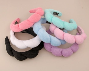 Detail of colorful braided terry cloth headbands in pink blue green and purple hues