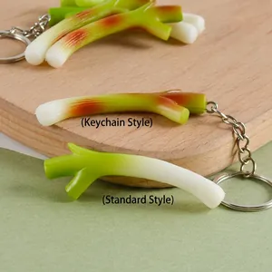 Realistic mini green onion keychain and vegetable model on a wooden board background