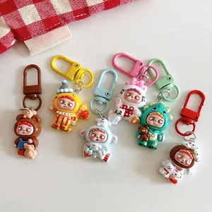 Close-up of six assorted cartoon resin keychains featuring cute bear and dinosaur shapes