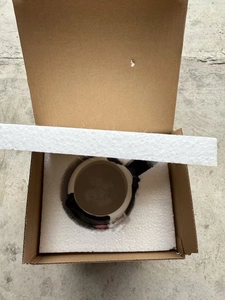 Detailed view of a 3D cow-shaped ceramic coffee mug packed securely in a foam-lined box