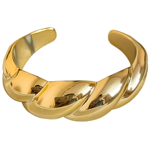 Polished gold twist cuff bracelet with a minimalist minimalist chunky croissant design