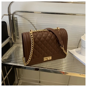Detailed shot of brown PU leather crossbody bag with diamond quilting and gold chain strap