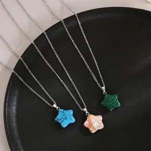 Detail of star-shaped natural stone necklaces in turquoise, orange, and green textures