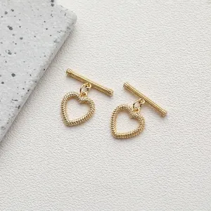 Macro shot of 14K gold-plated heart-shaped OT toggle clasp with beaded texture for DIY