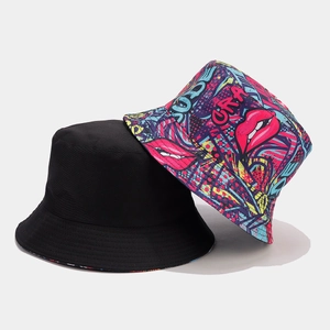 Close-up of reversible bucket hat featuring street art graffiti and minimalist black cotton