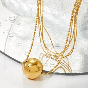 Chic multi-layer gold stainless steel necklace with a polished sphere pendant on mirror
