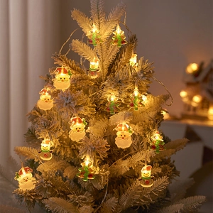 LED Christmas lights with Santa and snowman figures on a snowy tree in warm white