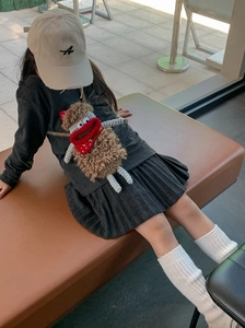 Detail view of a handmade brown crochet monster shoulder bag with a red mouth for kids