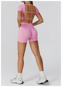 Detail of pink seamless yoga set featuring hollow out back top and high waist shorts