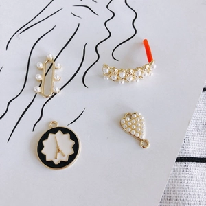 DIY gold alloy pendants with heart and cross designs featuring pearls and black enamel