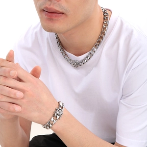 Polished silver stainless steel Cuban link chain necklace and bracelet set on male model