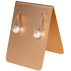 Elegant gold teardrop pearl hook earrings on a premium metal jewelry display stand