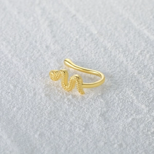 Close-up of golden snake nose cuff featuring detailed scales and a curved reptile design