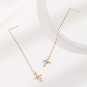 Elegant gold-plated cross drop earrings with micro-paved cubic zirconia on white background