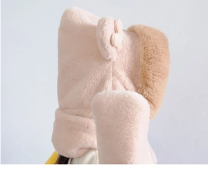 Detailed close-up of soft pink plush faux fur texture on child's winter hooded scarf