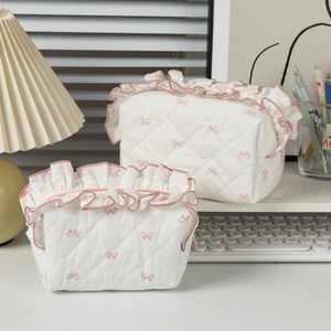Quilted cream cosmetic bag set with pink bow pattern and ruffle trim detailing