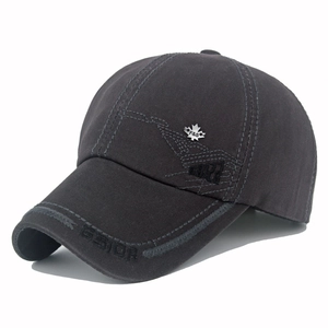 Detailed view of dark grey cotton baseball cap with F&S metal badge and embroidered brim
