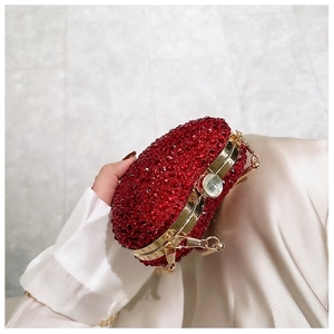 Macro detail of red rhinestone evening bag with gold metal frame and jewel clasp