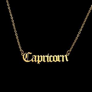 Detailed view of Capricorn gothic letter pendant on a gold stainless steel chain