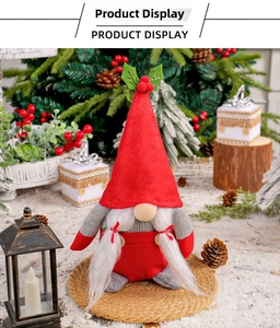 Detail of Christmas gnome plush with holly berries on red felt hat and wooden buttons