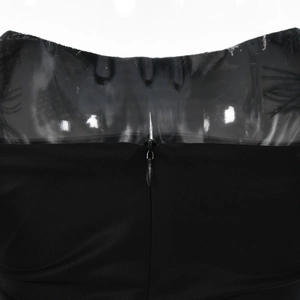 Close-up of the invisible zipper detail on the back of a black off-shoulder bodycon dress