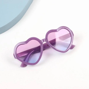 Detail of purple glitter heart sunglasses with blue pink gradient lenses and metal hinges