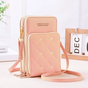 Quilted pink crossbody phone bag with three zipper compartments and adjustable strap