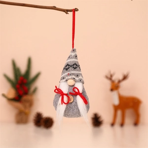 Grey Christmas gnome hanging ornament with knitted hat and red bow on wooden branch
