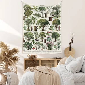 Detail view of a vintage botanical wall tapestry with French Arbres text in a cozy bedroom