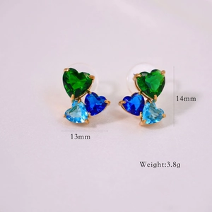 Macro shot showing green and blue heart-shaped zirconia studs with dimension and weight marks