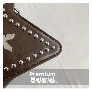 Detail of brown leather bag with silver rivets and metal butterfly buckle ornament