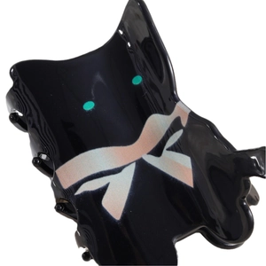 Abstract black acetate cat hair claw clip with green eyes and pearlescent bow detail