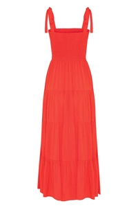 Detail of red tiered maxi dress featuring a smocked bodice and bow shoulder straps