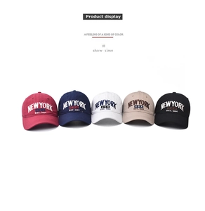 Five assorted cotton baseball caps in red, navy, white, khaki, and black with embroidery