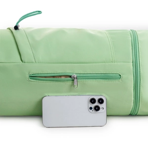 Detail of green waterproof yoga bag featuring a zipper pocket and drawstring closure